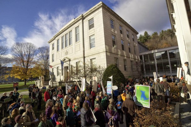 Protesters line up to enter the Pavilion Building in Montpelier, in which the governor's office is located. Photo by John Herrick/VTDigger