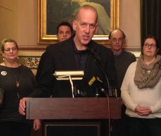 Bram Kleppner, director of Vermont Cures, speaks at a Statehouse rally Tuesday in support of publicly financed health care. Photo by Morgan True/VTDigger