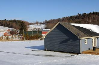 Patrick Perry's home (in the foreground) is now shaded from Ruth Dwyer's view with a large blind she erected in her front yard in Thetford. Photo by Sarah Priestap/Valley News 