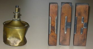 Among the mementos from her father's shop that Mary Leahy keeps in her house is the letterpress type that once printed the "ICE" cards that people would put in their front windows when they wanted the iceman to make a delivery. Beautifully rendered in wood to begin with, the letter faces are as smooth as glass after decades of use. Beside them is a well-used brass can that contained solvent to clean the type. Photo by Nancy Graff