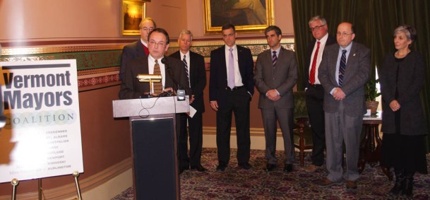 Barre Mayor Thom Lauzon speaks a news conference Tuesday, Jan. 13, 2015, held by the Vermont Mayors Coalition. Other mayors attending were (from left) Mike O'Brien of Winooski; John Hollar of Montpelier; Chris Louras of Rutland; Miro Weinberger of Burlington; Bill Benton of Vergennes; Paul Monette of Newport; and Liz Gamache of St. Albans. Photo by Tom Brown/VTDigger