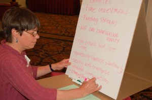 Merrick Grutchfield, a guardian ad litem, puts down her group's ideas at a Youth Justice summit convened by the Department of Children and Families on Friday. The subject was truancy and helping students who are missing school. Photo by Amy Ash Nixon/VTDigger 