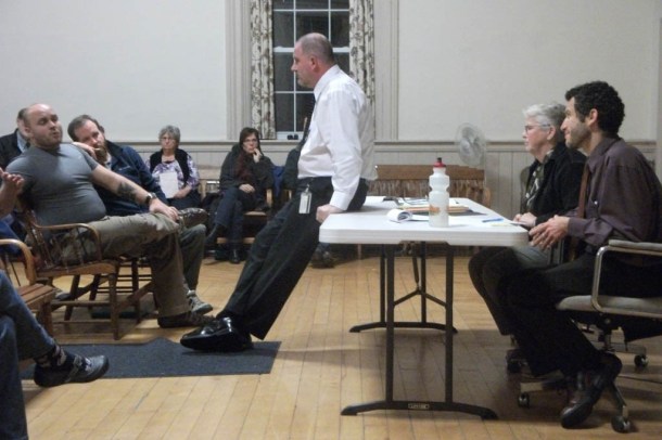 Chester residents speak with state Department of Corrections staffers (seated on and at table) at a fall public meeting about the opening of a local “transition” house for newly released prisoners. Photo by Kevin O'Connor/VTDigger 