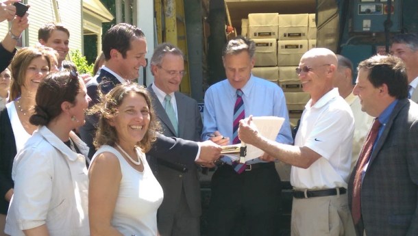 Gov. Peter Shumlin (center) signs S.40, which sets Vermont's renewable policy, at a home in Montpelier on Thursday. Flanking him are Sen. Chris Bray (left), D-Addison, and Rep. Tony Klein, D-East Montpelier. Photo by Sarah Olsen/VTDigger