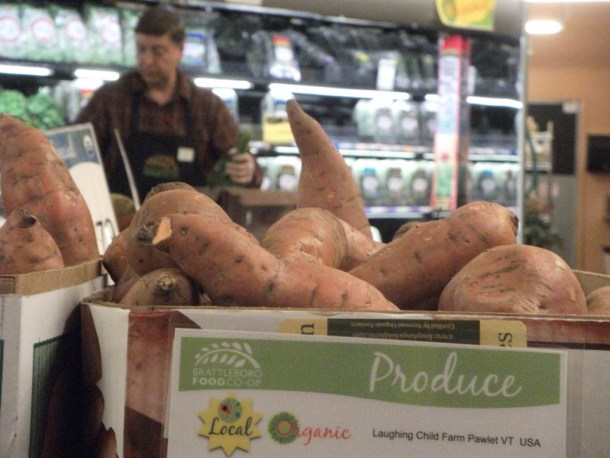 A worker stocks produce at the Brattleboro Food Co-op. Photo by Kevin O’Connor/for the Valley News