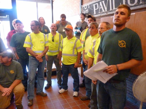 Leavitt Sayers, a truck driver and maintenance worker at the Agency of Transportation’s garage in Williamstown, delivers a petition to the Pavilion building Tuesday. Photo by Morgan True/VTDigger