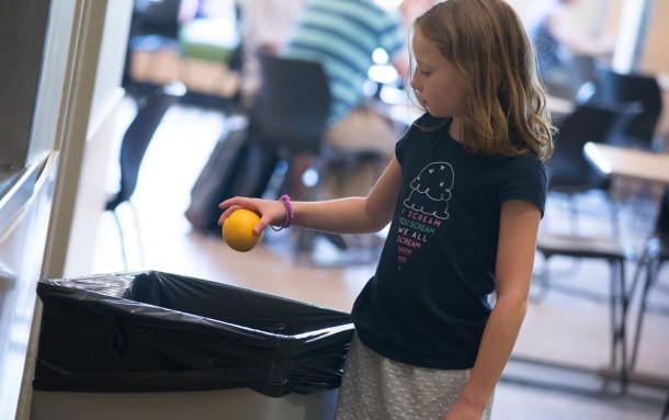 Throwing fruit in trash from a nutritional school lunch. Courtesy photo Sally McCay/UVM Photo