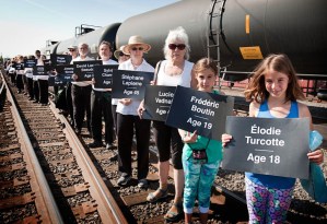 Demonstrators in Portland, Maine, hold signs bearing the names of those killed in a crude oil explosion in Lac Megantic, Quebec. Courtesy photo