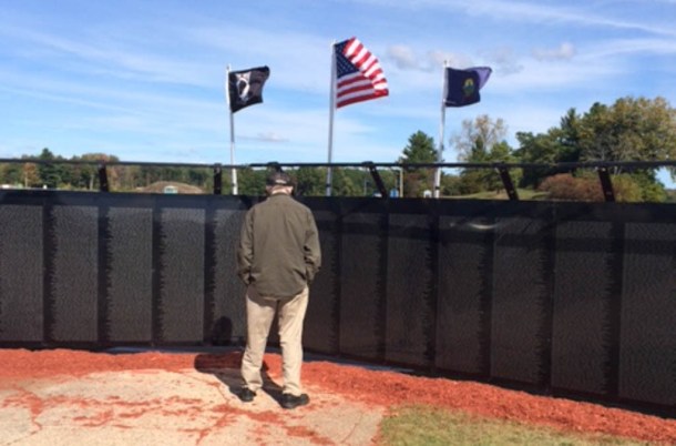 A veteran takes in the half-sized replica of the Vietnam Veterans Memorial on Thursday. Photo by Mark Johnson/VTDigger.