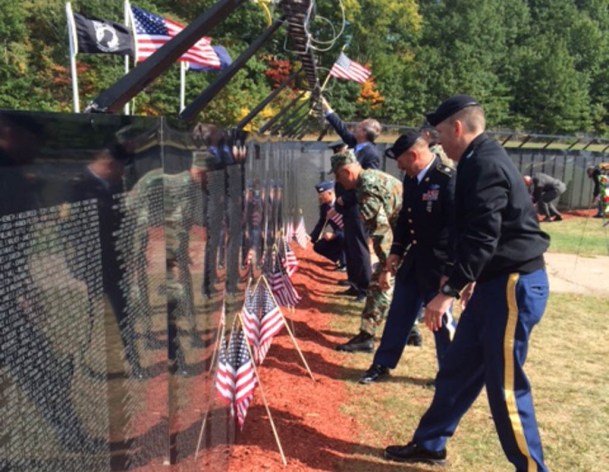 Former members of the armed forces take in the Vietnam Veterans Memorial replica in Essex Junction. Photo by Mark Johnson/VTDigger.
