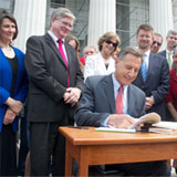 Peter Shumlin signed the historic health care reform act on the Statehouse steps on Thursday. VTD/Taylor Dobbs.