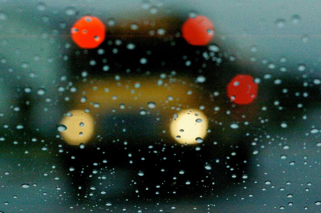 View of a school bus through a rainy window.