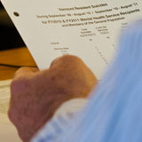 A legislator looks over FY2010 and FY2011 Vermont suicide statistics during a mental health hearing at the Statehouse. VTD/Josh Larkin
