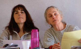 Elmore School Board members Penny Jones, chair, left, and Peggy Sprague, right, informing the floor of the Elmore Town Meeting that the vote in neighboring Morrisville on a merger study was approved unanimously there. Elmore voted 79 to 19 to enter a merger study. Ultimately, voters in both towns would have to vote on an actual merger; Tuesday's votes are only to study what a merger would mean for the two adjoining school districts.