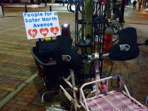 A New North End resident bedecked his bicycle with a sign showing support for a proposed traffic pilot. Photo by Morgan True / VTDigger