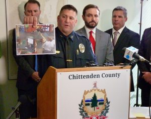 Winooski Police Chief Rick Hebert holds up a photo of the suspect bank robbery. Photo by Morgan True / VTDigger