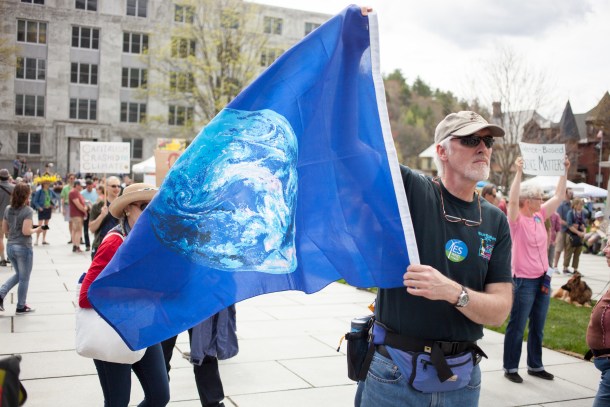 Man holding earth flag