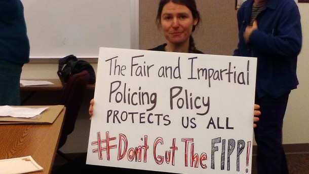 A woman holding a sign.