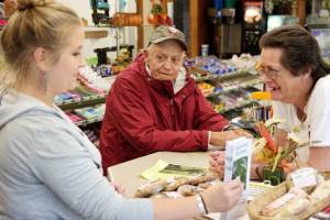 A customer chats with employees at the Chelsea Quik-Stop