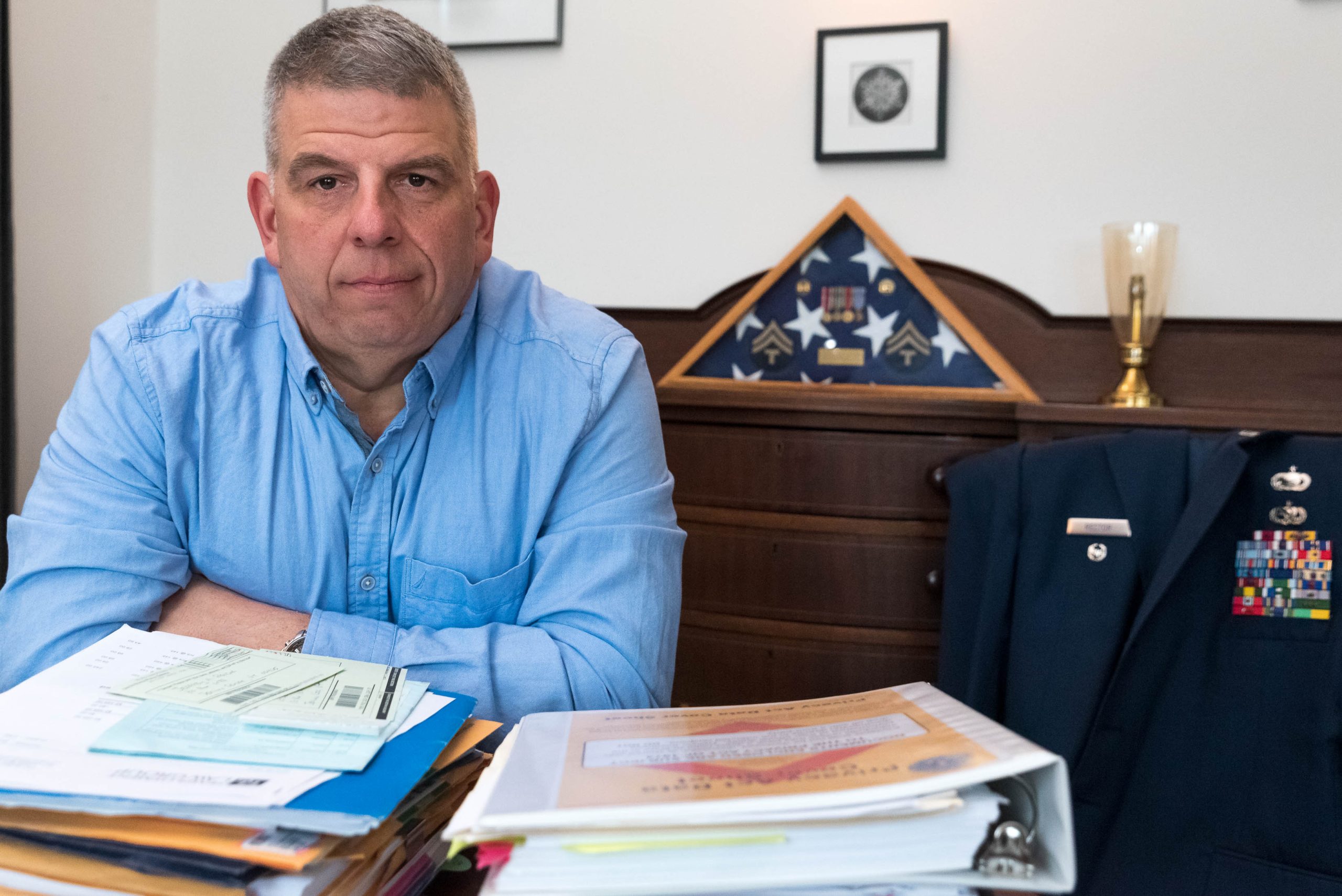 Jeff Rector sits behind his desk