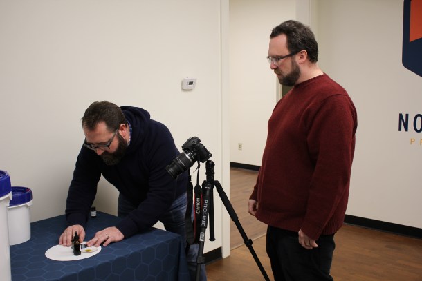 Noah Quist (left) and Carl Christianson (right) prepare CBD products for a photoshoot.