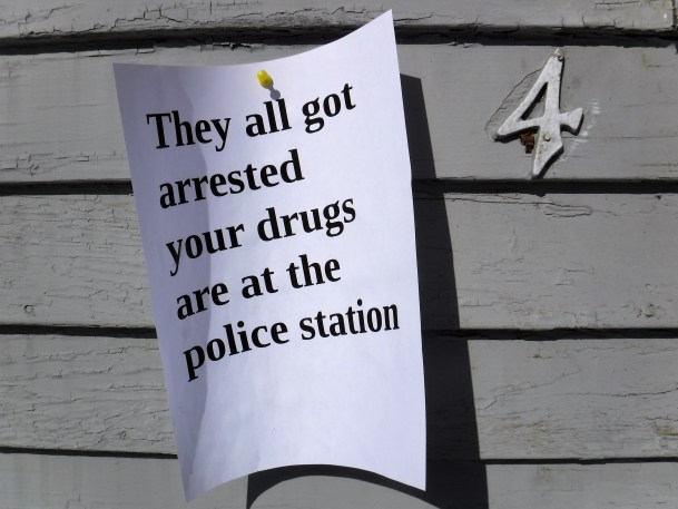 A sign is tacked to the side of Brattleboro’s 33 Oak St. after police raided an apartment there Thursday, Feb. 28, 2019. Photo by Kevin O’Connor/VTDigger