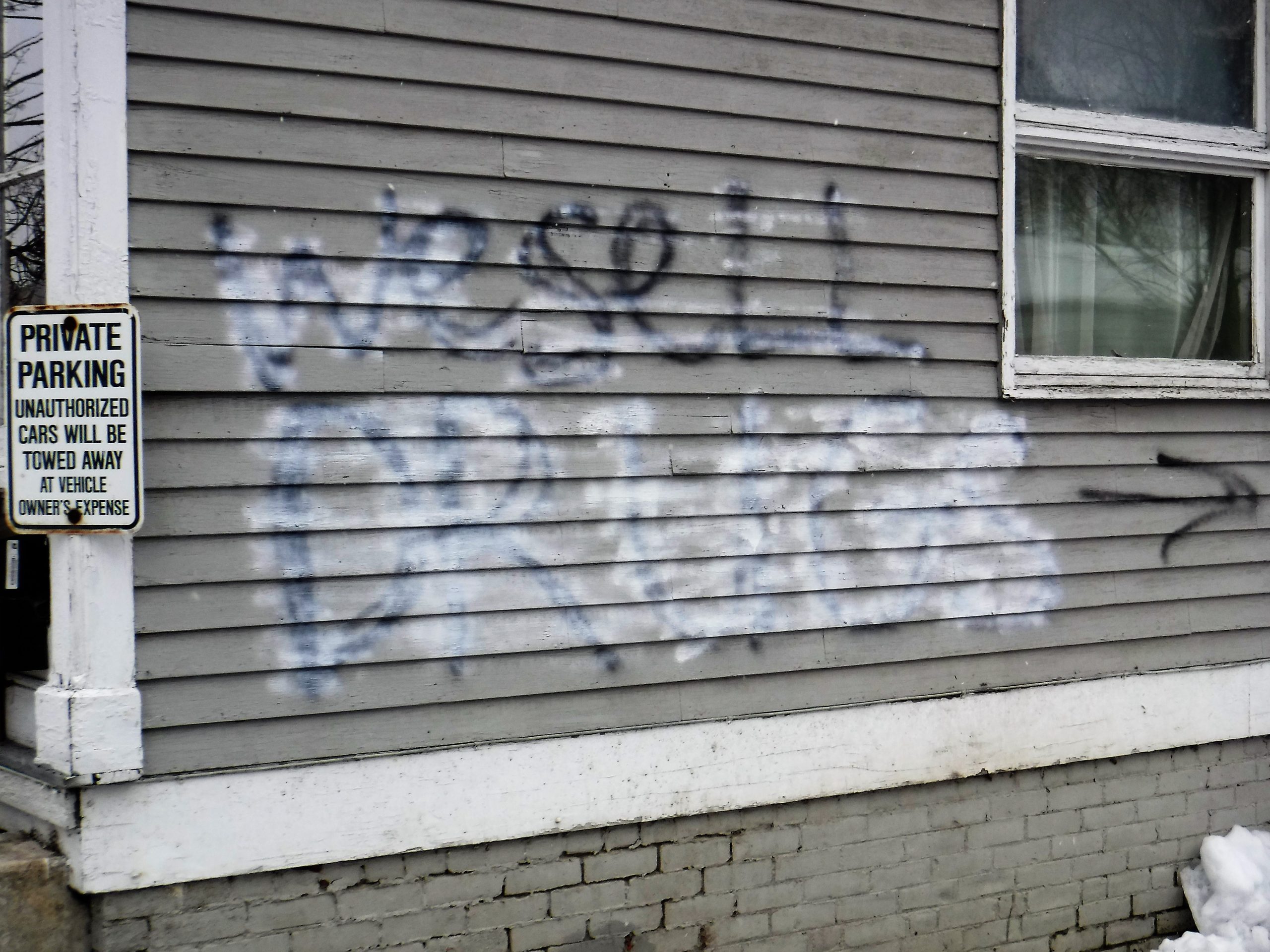 The remnants of the recently spray-painted words “we sell drugs” can still be seen at Brattleboro’s 33 Oak St.