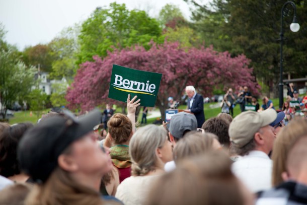 Crowd member holding Bernie sign
