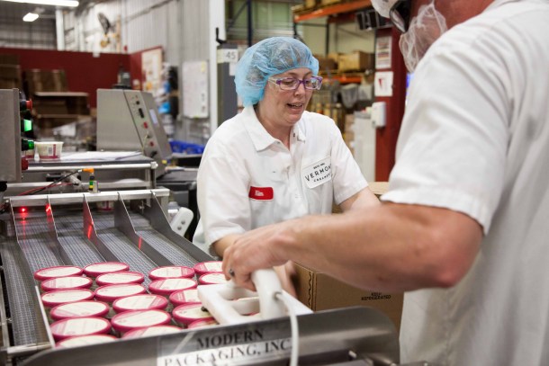 Employees package tubs of creme fraiche