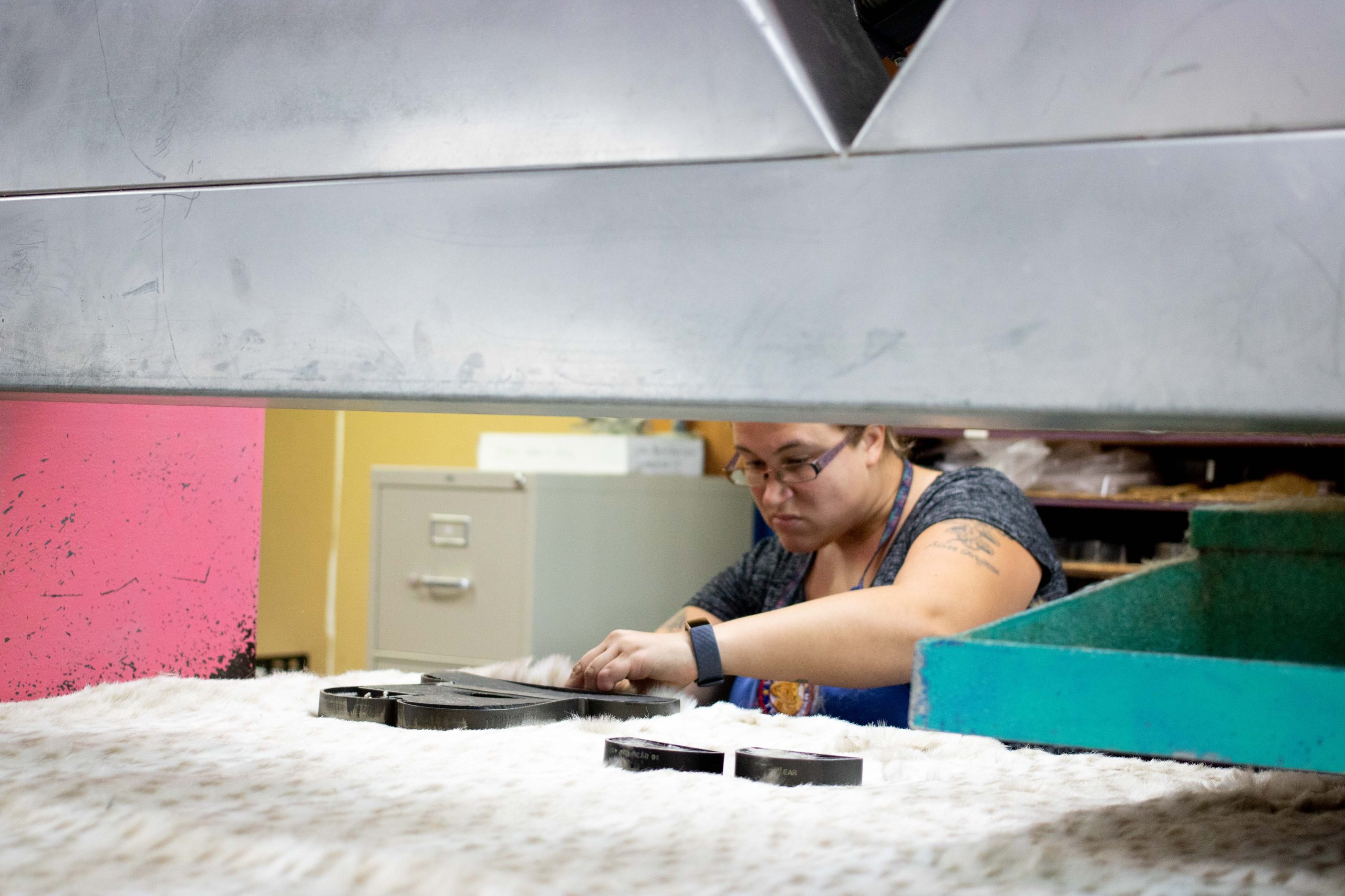 worker arranging dies under press