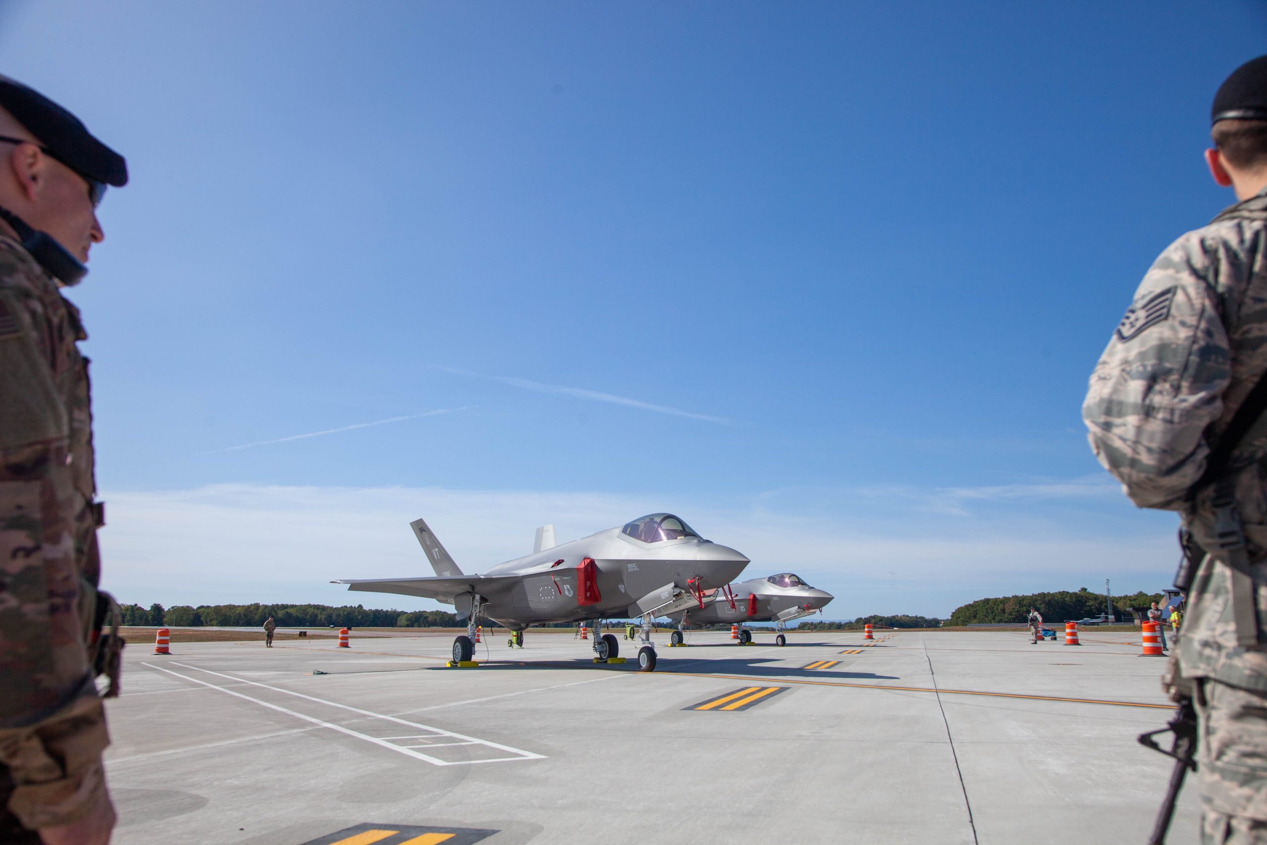 An F-35 plane and two soldiers