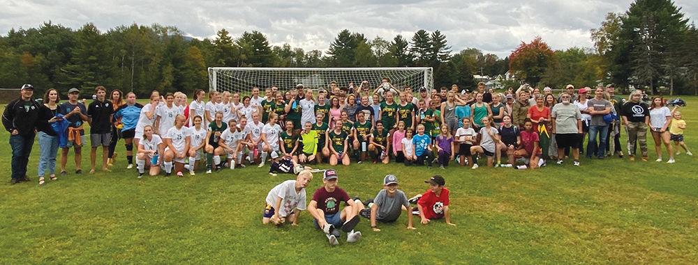 The Peoples Academy and Stowe High girls soccer teams gathered on the field in Morrisville with community members on Monday to take a photo together to demonstrate unity and camaraderie after their annual rivalry game. Stowe won the game, 1-0 on a last minute goal. Courtesy photo