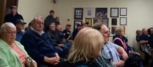 A crowd listens to debate