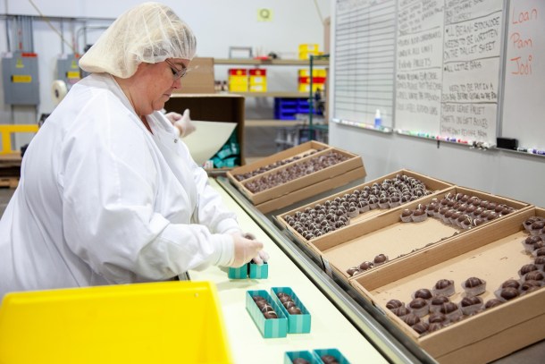 Employee packaging chocolate truffles