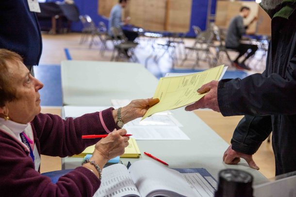 voter picking up ballot