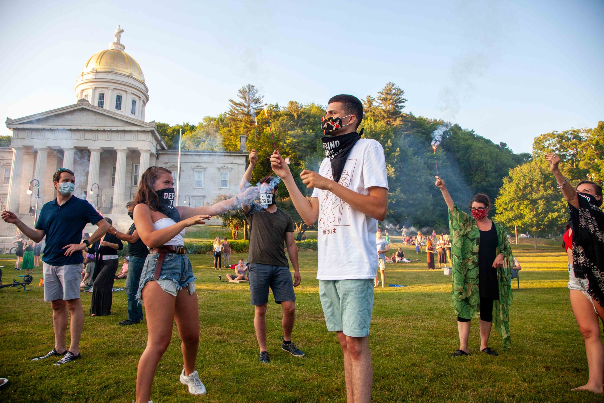 People holding sparklers on Statehouse lawn