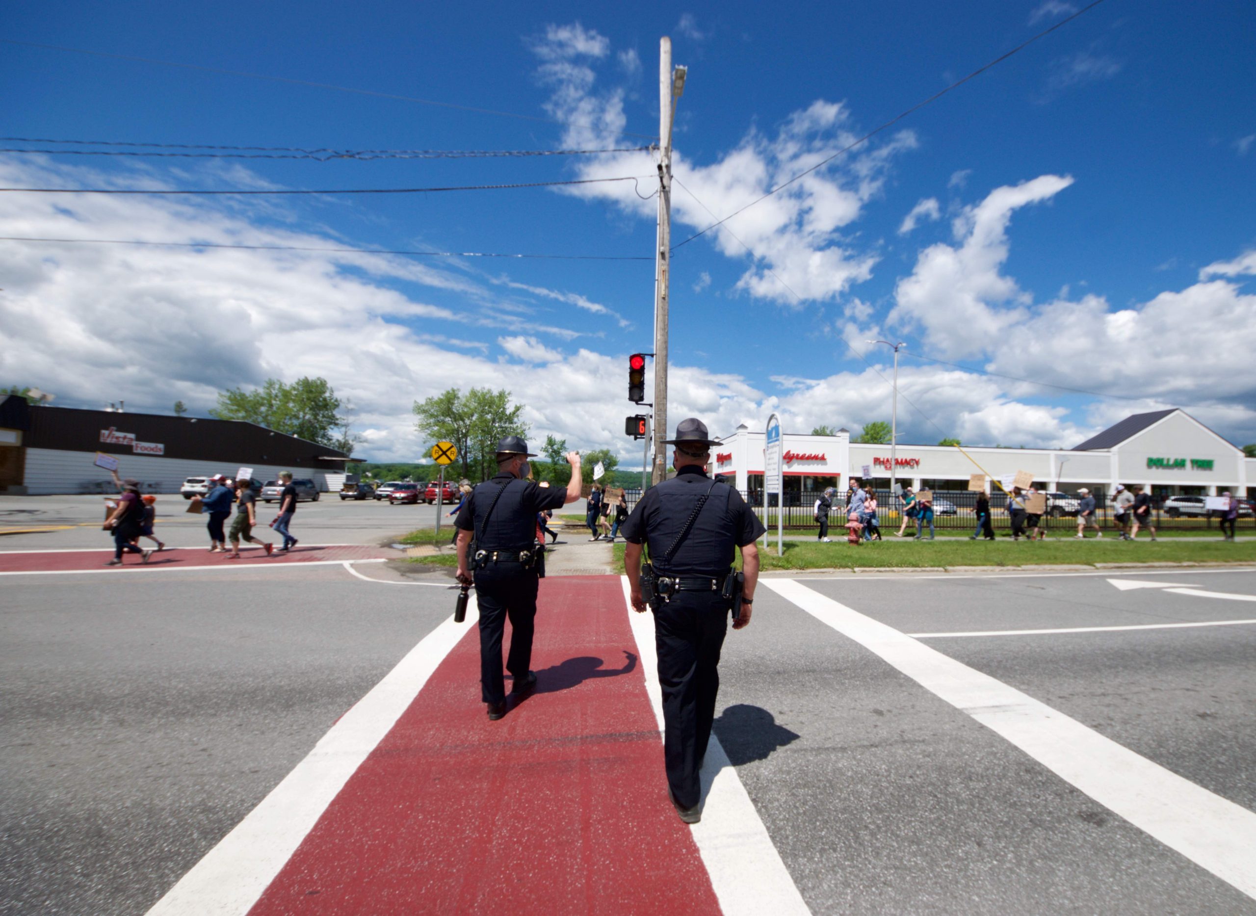 Police stood by as people marched along the streets in Newport on Sunday, June 7, 2020, as part of Black Lives Matters protests across the country in response to Minneapolis police killing George Floyd. Photo by Justin Trombly/VTDigger