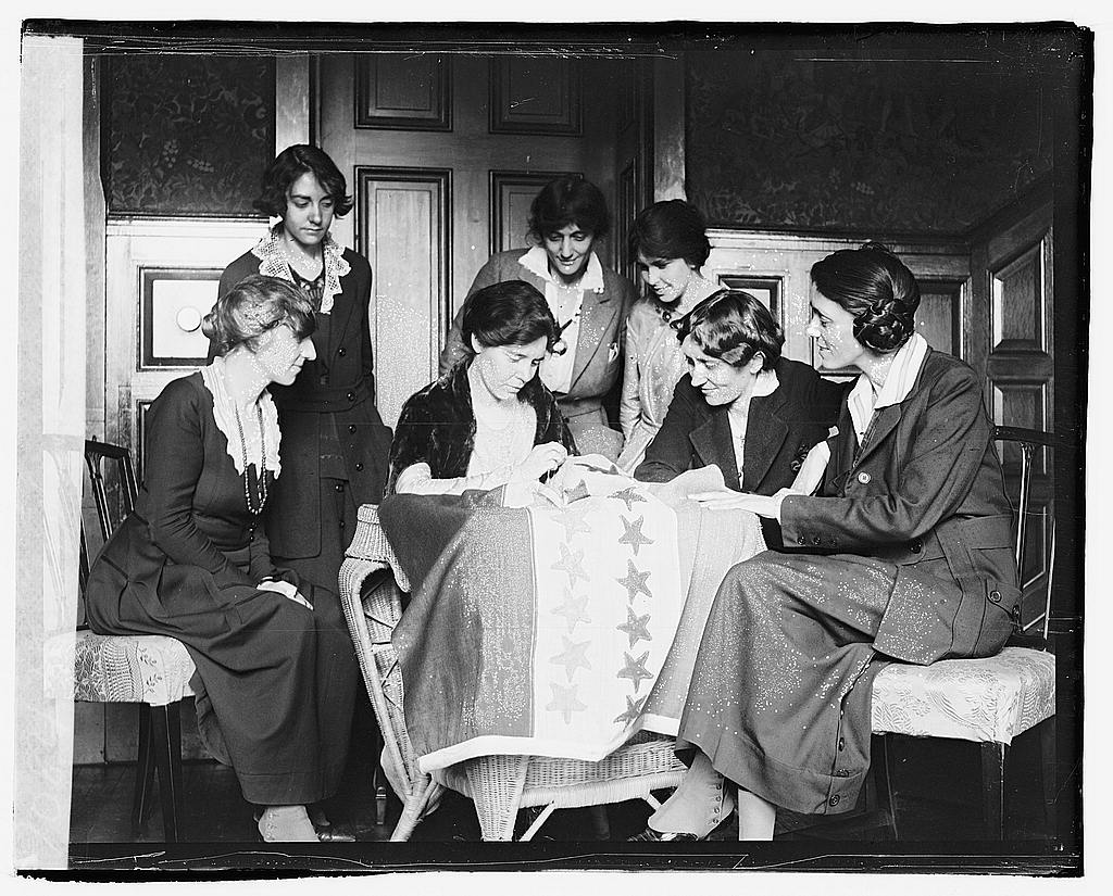 women sewing suffrage flag
