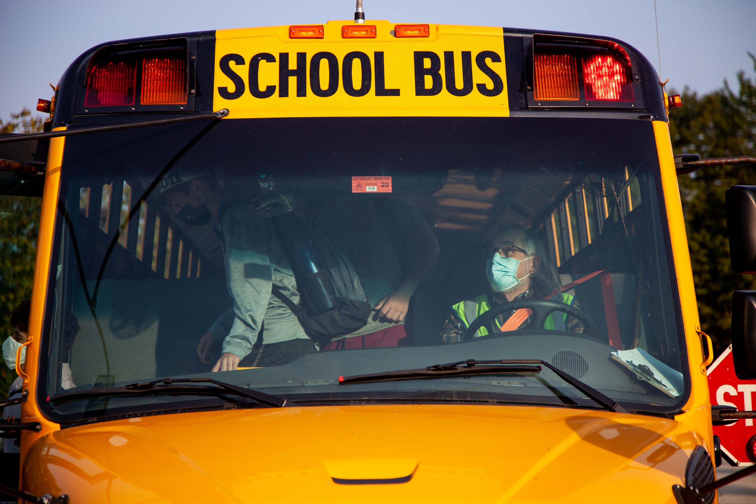 Masked driver inside school bus