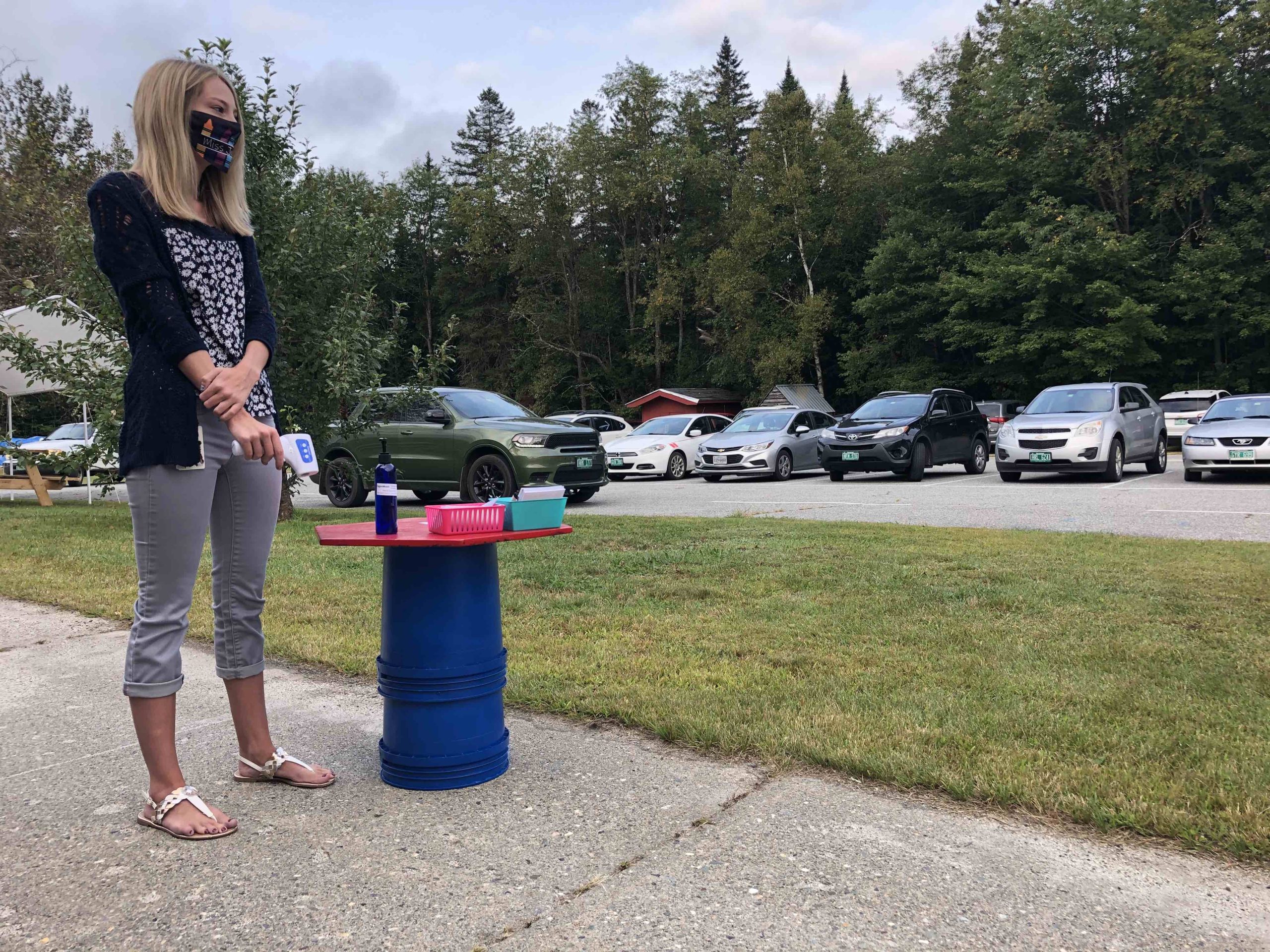 Michaela Jokinen, a first-grade teacher at Brighton Elementary School in Island Pond, runs a health check and sanitization station as students arrive Tuesday morning. Justin Trombly/VTDigger
