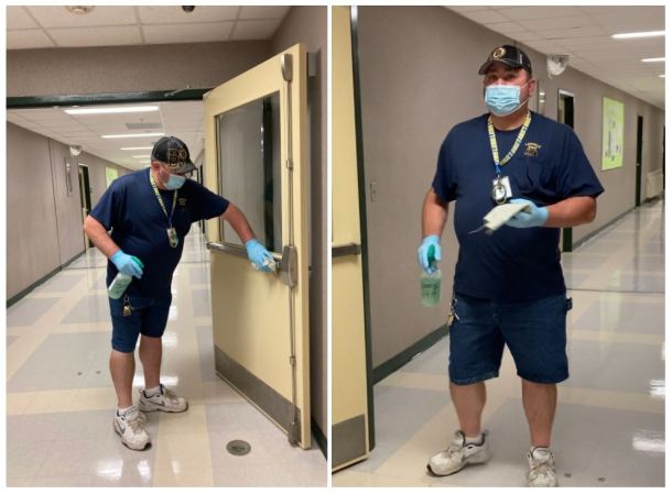 Custodian John Lehouiller wipes down door handles at Lamoille Union High School