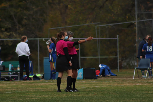 Lynn Vera (right) and Kristina Sickmueller officiating a field hockey game this fall.