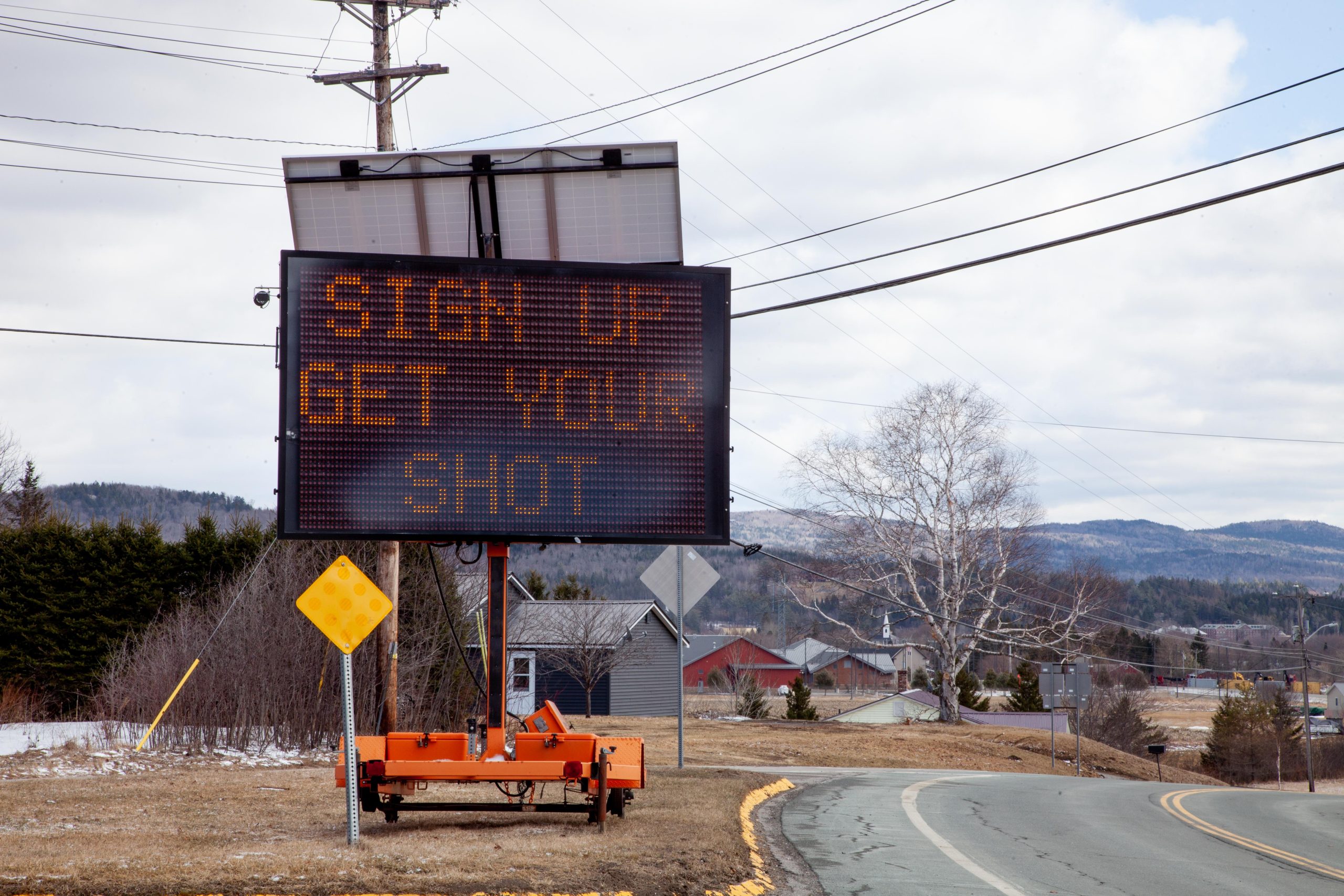 Sign reading "sign up get your shot"