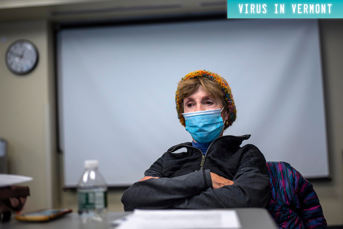 Woman in mask with arms crossed