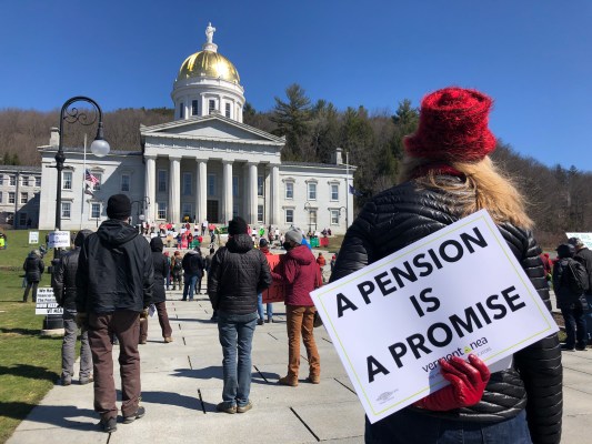 Crowd at statehouse protest; woman with sign reading "a pension is a promise"