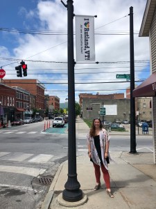 Jeannette Langston is pictured in downtown Rutland below an "I Love Rutland" Pride banner.