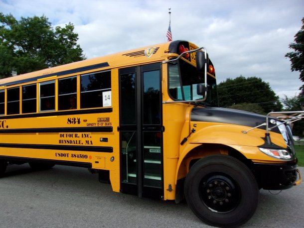 Dufour yellow school bus parked in a parking lot