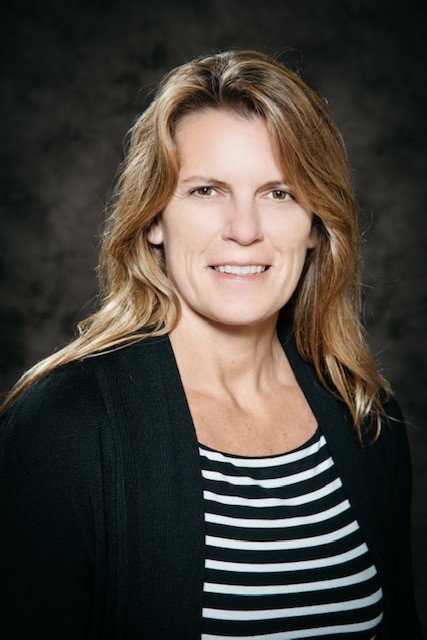 A woman wearing a black and white striped shirt.