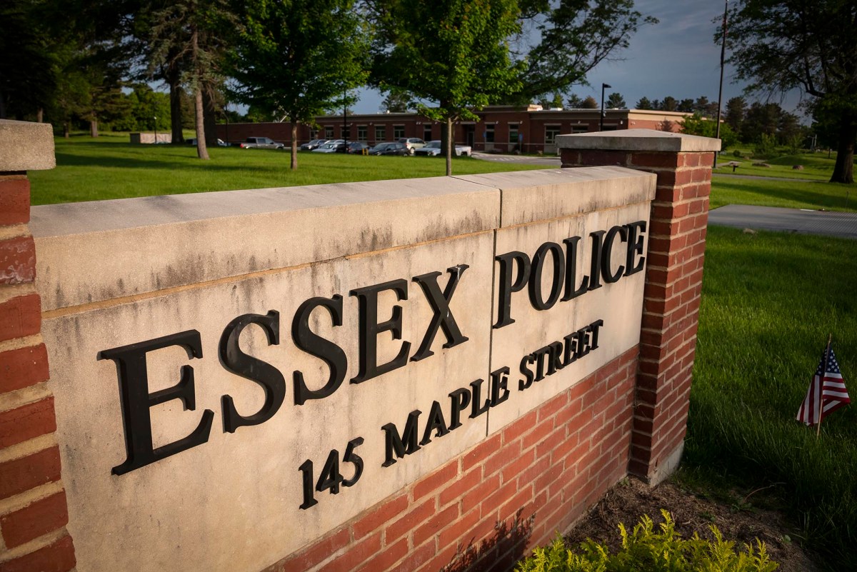 Essex police sign in front of a grassy field.