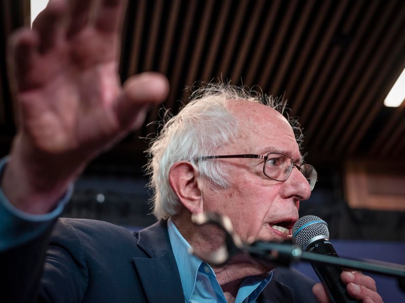 Bernie sanders speaks into a microphone.